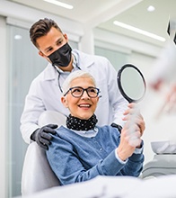 mature woman smiling at dentist’s office 