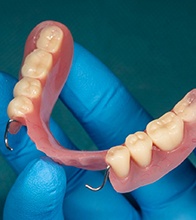 a full denture sitting on a plaster mold of a mouth