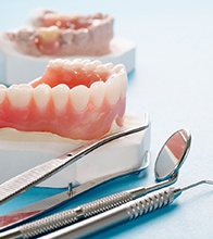 a model of dental implants supporting a denture