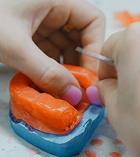 Technician building a wax mold