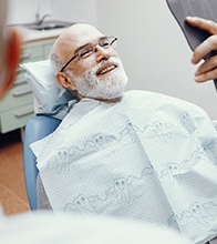 Man trying on dentures at dentist’s office