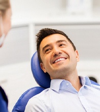 Man sitting back in chair for gum disease therapy in Blaine, MN