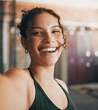 a healthy woman smiling with dental implants