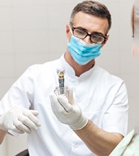 dentist explaining dental implant to patient