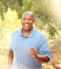 An older man walking outside