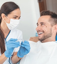 dentist showing Invisalign to a patient 