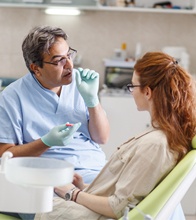 Dentist discussing treatment with dental patient