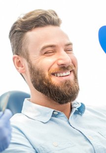 patient smiling in dental mirror