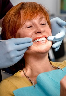 patient smiling in dental mirror 