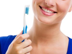 woman holding toothbrush
