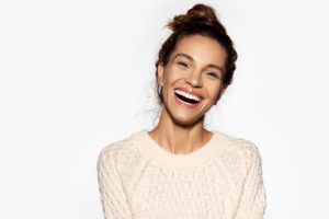 Woman smiling with porcelain veneers in Blaine  