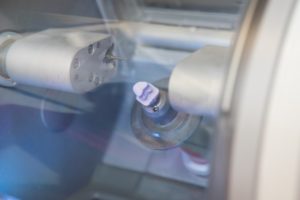 a milling unit fabricating a custom-made dental crown while a patient waits