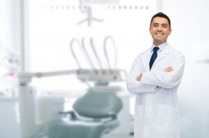 a male dentist smiling