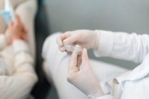 dentist holding clear aligners